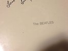 THE BEATLES WHITE ALBUM SIGNED BY LOU HARRISON AND STILL SEALED.