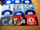 THE POLICE 6 PACK BLUE VINYL PIC SLEEVES +PVC HOLDER