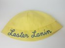 Yellow Cotton Lester Lanin Hat With A White Ball On Top Name In Blue Script