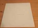 The beatles white album with poster and pictures.