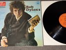 FREE BOB DYLAN WHILE THE ESTABLISHMENT BURNS, BLUE VINYL with Greatest Hits.